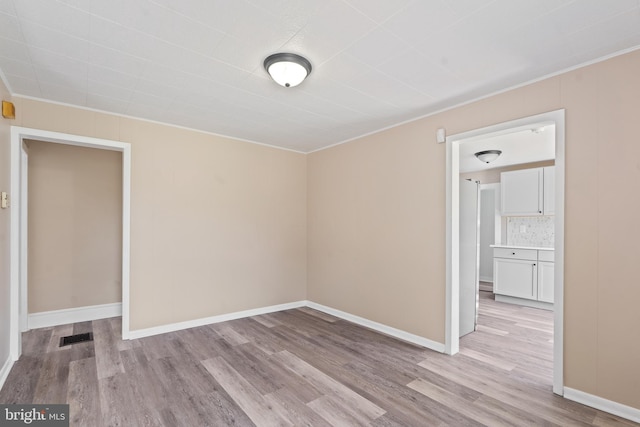 311 W Washington St, Paulsboro, NJ 08066 - unfurnished room featuring crown molding, light wood finished floors, and baseboards