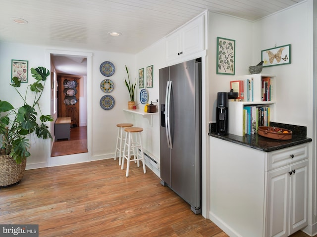 1180 Radnor Hill Rd, Wayne, PA 19087 - kitchen featuring stainless steel fridge, white cabinetry, light wood-style floors, recessed lighting, and a baseboard heating unit