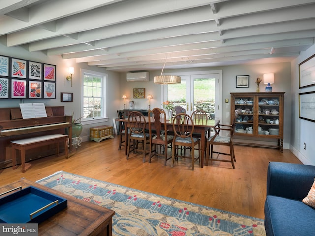 1180 Radnor Hill Rd, Wayne, PA 19087 - dining room with a wall mounted AC, wood finished floors, beam ceiling, healthy amount of natural light, and baseboards