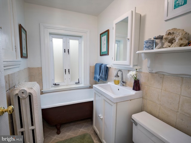 1180 Radnor Hill Rd, Wayne, PA 19087 - bathroom with radiator heating unit, toilet, a freestanding bath, vanity, and tile patterned floors