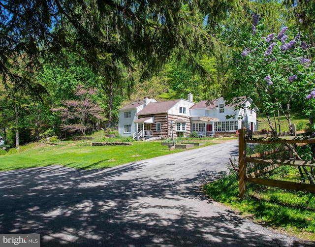 1180 Radnor Hill Rd, Wayne, PA 19087 - view of front of home featuring asphalt driveway, a chimney, and a front yard