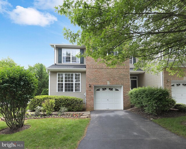 14 Coolidge Way, Princeton, NJ 08540 - traditional-style house with asphalt driveway, a garage, brick siding, and a front lawn
