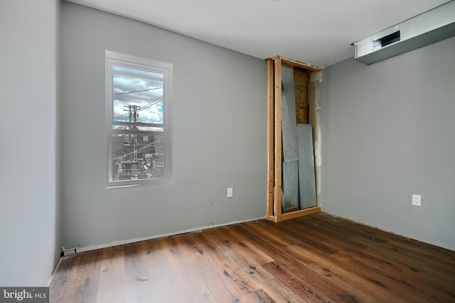 2213 E Madison St, Baltimore, MD 21205 - empty room with dark wood-type flooring