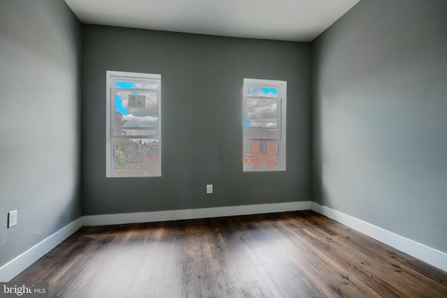 2213 E Madison St, Baltimore, MD 21205 - empty room with dark wood finished floors and baseboards