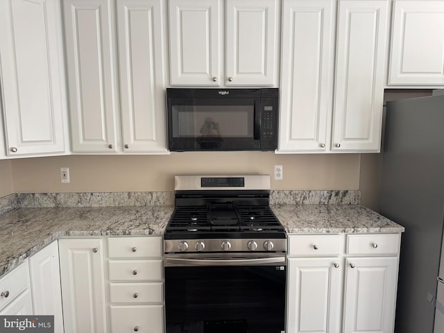 2155 Sewanee Dr, Forest Hill, MD 21050 - kitchen featuring appliances with stainless steel finishes, white cabinetry, and light stone countertops