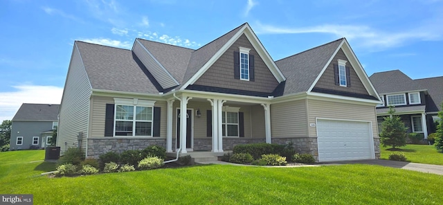1606 Trotter St, Frederick, MD 21702 - craftsman-style house featuring stone siding, covered porch, a front lawn, and an attached garage