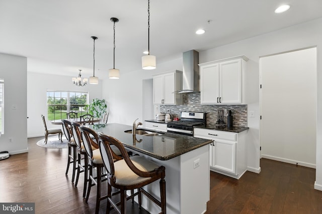 1606 Trotter St, Frederick, MD 21702 - kitchen with a sink, wall chimney exhaust hood, stainless steel range with gas stovetop, backsplash, and a kitchen breakfast bar