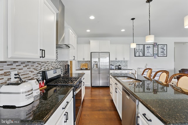 1606 Trotter St, Frederick, MD 21702 - kitchen featuring appliances with stainless steel finishes, a sink, wall chimney range hood, white cabinetry, and decorative backsplash