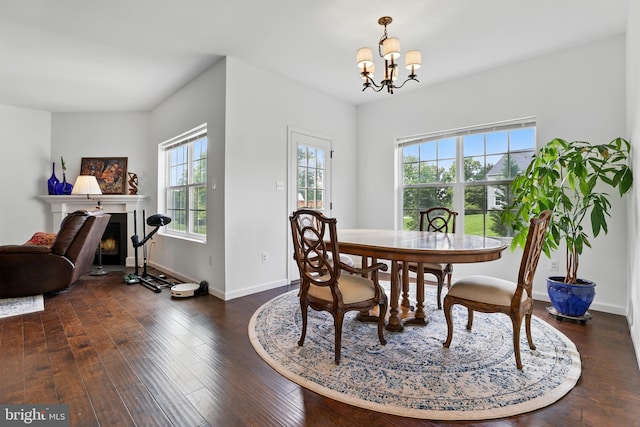1606 Trotter St, Frederick, MD 21702 - dining space with dark wood finished floors, a chandelier, a fireplace with flush hearth, and baseboards