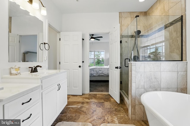 1606 Trotter St, Frederick, MD 21702 - ensuite bathroom with vanity, a freestanding bath, a shower stall, ceiling fan, and stone finish flooring