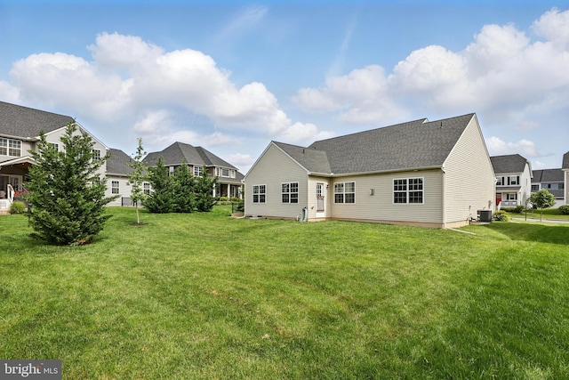 1606 Trotter St, Frederick, MD 21702 - back of house with central air condition unit, a lawn, and a residential view