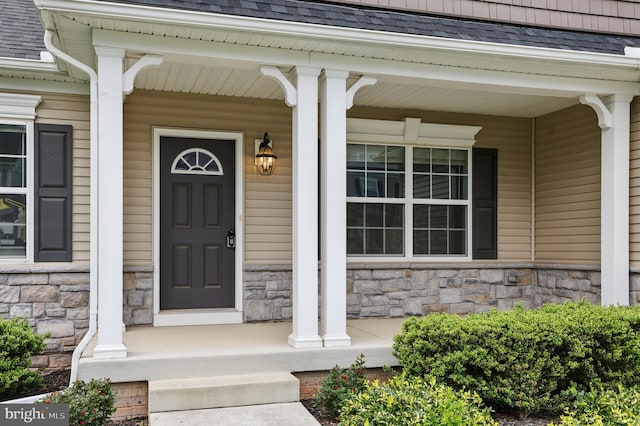 1606 Trotter St, Frederick, MD 21702 - doorway to property featuring a porch, roof with shingles, and stone siding