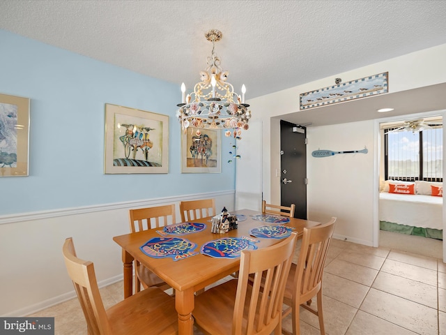 504GEORGETOWNEHOUSERD Georgetowne House Rd Unit 504, Bethany Beach, DE 19970 - dining area featuring a chandelier, a textured ceiling, and light tile patterned flooring