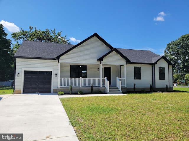 modern inspired farmhouse with a porch, a garage, concrete driveway, and a front yard
