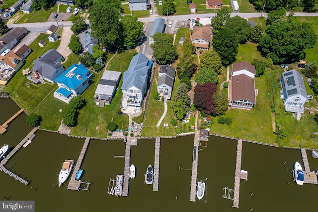 aerial view of property's location featuring a nearby body of water and nearby suburban area