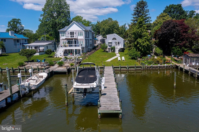 dock area featuring boat lift, a water view, a yard, and stairway