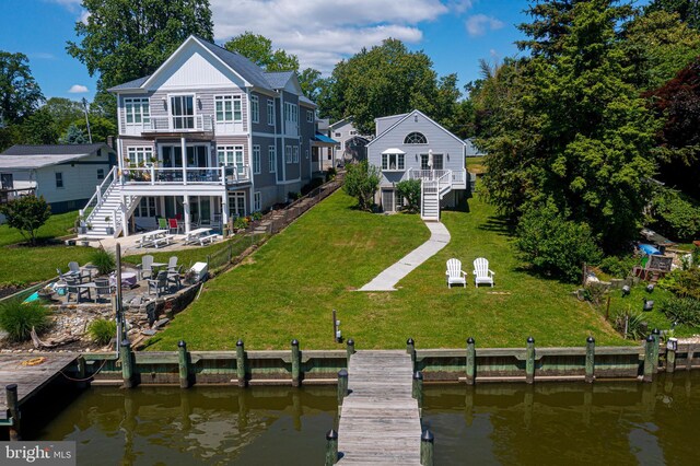 back of property with stairs, a deck with water view, and a balcony