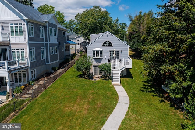 view of front facade with stairs, board and batten siding, and a deck