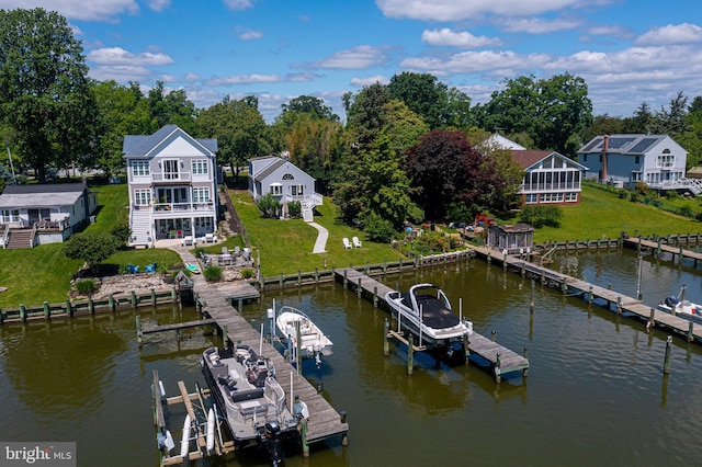 dock area with boat lift, a patio, stairs, a yard, and a balcony
