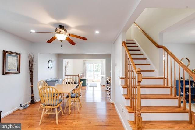 dining room featuring light wood-style flooring, stairs, ceiling fan, recessed lighting, and baseboards