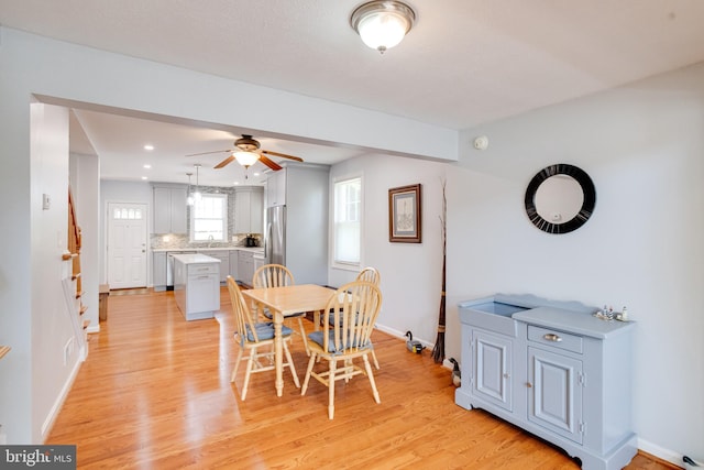 dining space with a ceiling fan, baseboards, light wood-style floors, and recessed lighting
