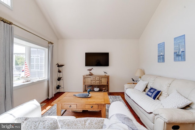 living area with vaulted ceiling, wood finished floors, and baseboards