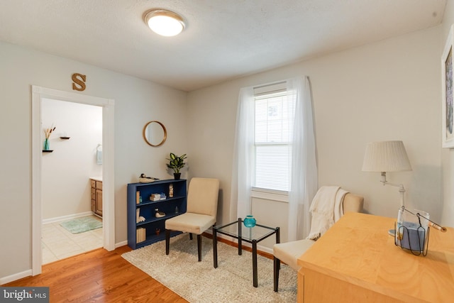 living area with light wood-style floors and baseboards