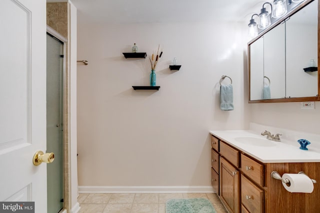 full bathroom with vanity, baseboards, and a shower with door