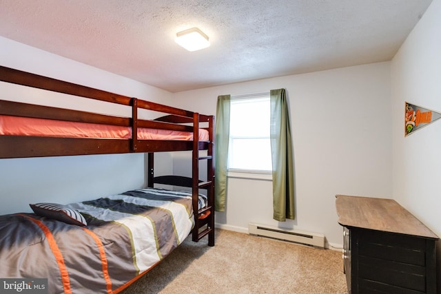 bedroom featuring baseboard heating, a textured ceiling, carpet floors, and baseboards
