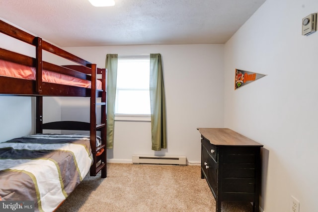 carpeted bedroom featuring baseboard heating and baseboards