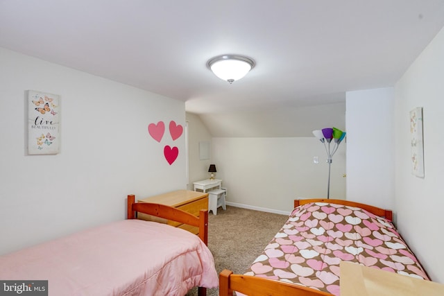 carpeted bedroom featuring lofted ceiling and baseboards