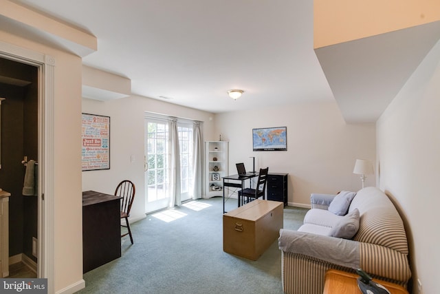 carpeted living area with baseboards