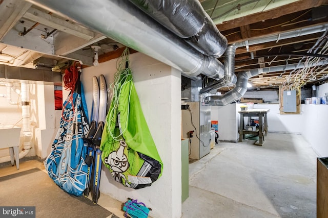 unfinished basement with electric panel and heating unit