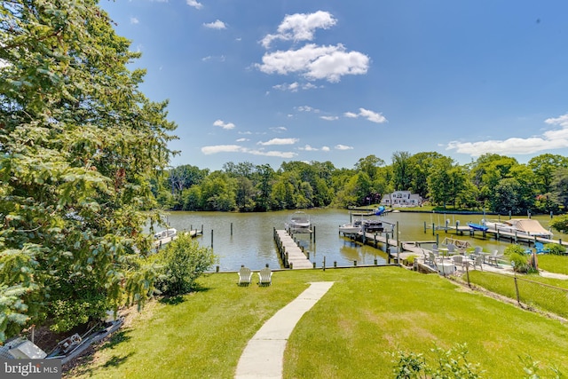dock area with a water view and a lawn