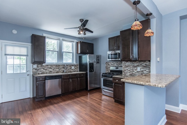 3539 Almond St, Philadelphia, PA 19134 - kitchen featuring stainless steel appliances, a peninsula, ceiling fan, and decorative backsplash