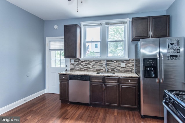 3539 Almond St, Philadelphia, PA 19134 - kitchen with appliances with stainless steel finishes, a sink, dark wood finished floors, decorative backsplash, and baseboards
