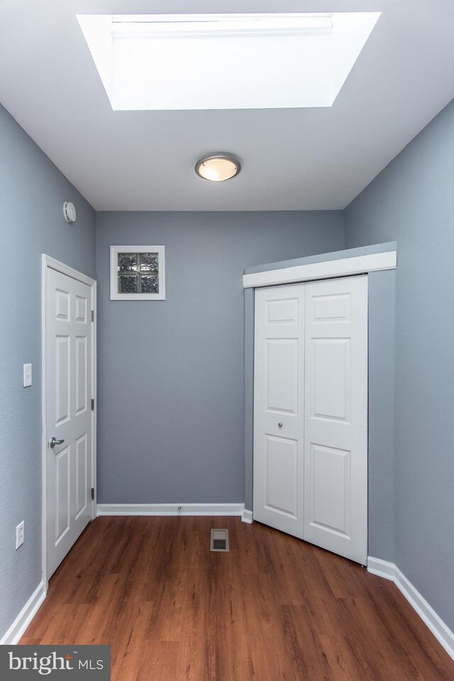 3539 Almond St, Philadelphia, PA 19134 - unfurnished bedroom featuring a skylight, wood finished floors, baseboards, and a closet