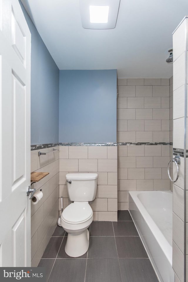 3539 Almond St, Philadelphia, PA 19134 - full bathroom featuring tile walls, toilet, tile patterned flooring, wainscoting, and shower / bathtub combination