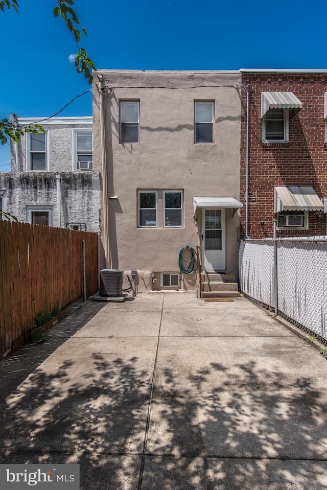 3539 Almond St, Philadelphia, PA 19134 - back of house featuring stucco siding, central air condition unit, and a patio
