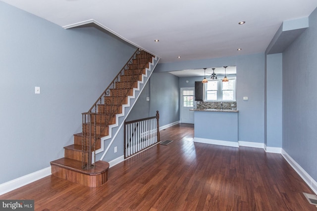 3539 Almond St, Philadelphia, PA 19134 - unfurnished living room featuring baseboards, dark wood-type flooring, stairway, and recessed lighting