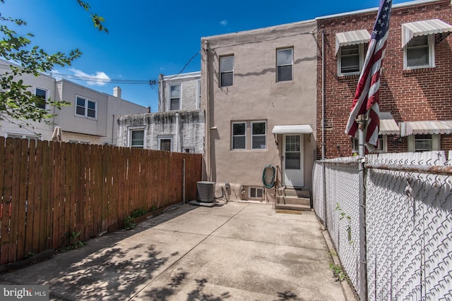 3539 Almond St, Philadelphia, PA 19134 - rear view of house with entry steps, stucco siding, brick siding, and a patio