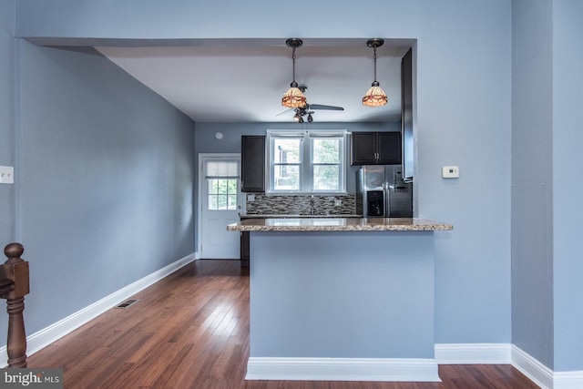 3539 Almond St, Philadelphia, PA 19134 - kitchen featuring stainless steel refrigerator with ice dispenser, dark wood-style floors, a peninsula, and light stone countertops