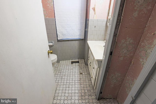 1721 Ruxton Ave, Baltimore, MD 21216 - bathroom with tile walls, vanity, toilet, and tile patterned floors