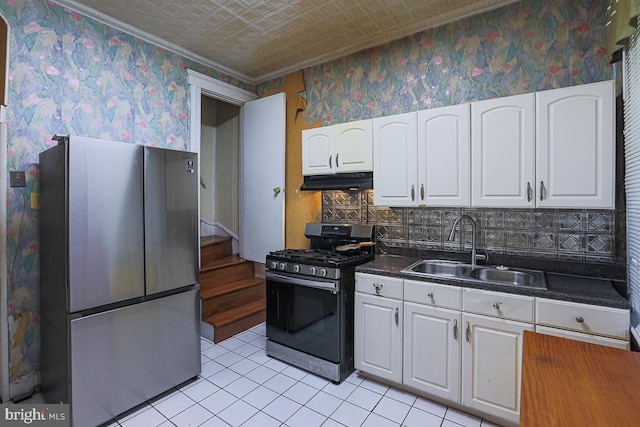 1721 Ruxton Ave, Baltimore, MD 21216 - kitchen featuring stainless steel appliances, a sink, white cabinetry, under cabinet range hood, and an ornate ceiling