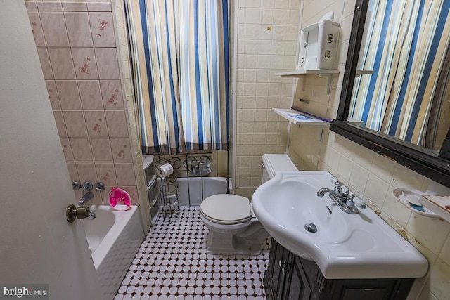 1721 Ruxton Ave, Baltimore, MD 21216 - bathroom with toilet, vanity, and tile walls