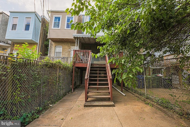 1721 Ruxton Ave, Baltimore, MD 21216 - rear view of property with stairs, stucco siding, and a wooden deck