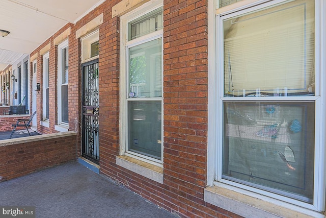 1721 Ruxton Ave, Baltimore, MD 21216 - doorway to property featuring covered porch and brick siding