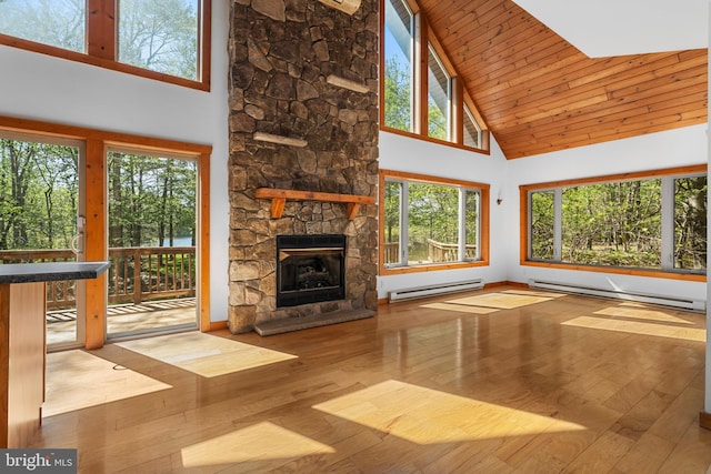 2107 Lenape Ter, Canadensis, PA 18325 - unfurnished living room with a baseboard radiator, high vaulted ceiling, a stone fireplace, wood-type flooring, and wood ceiling