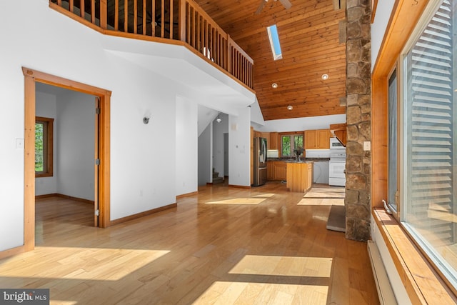 2107 Lenape Ter, Canadensis, PA 18325 - unfurnished living room with high vaulted ceiling, baseboards, light wood-style floors, a sink, and wooden ceiling