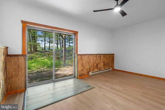 2107 Lenape Ter, Canadensis, PA 18325 - unfurnished room with baseboard heating, wood finished floors, and a ceiling fan